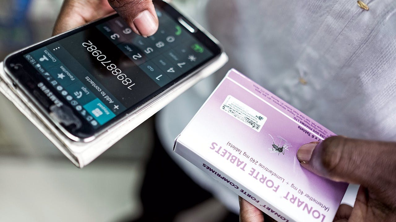 Photo of a smartphone next to medication