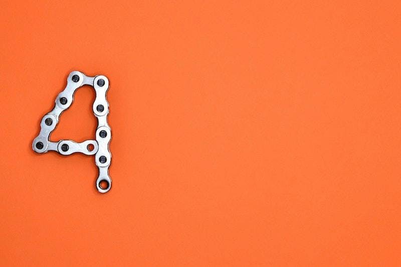 A silver number four on an orange background