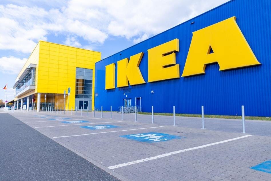 An image of a large, yellow IKEA logo on an IKEA storefront