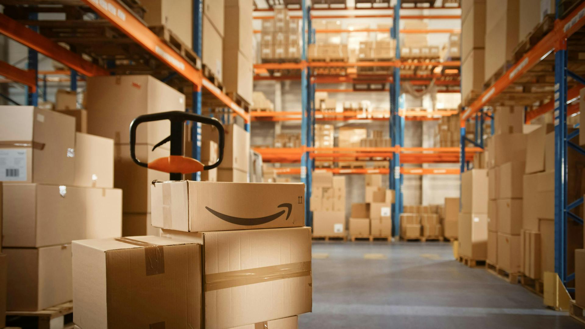 Amazon boxes piled up in a warehouse.