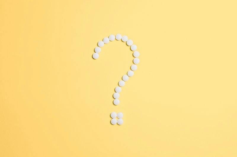 A white question mark on a yellow background