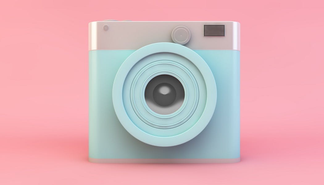 Image of a camera on pink background