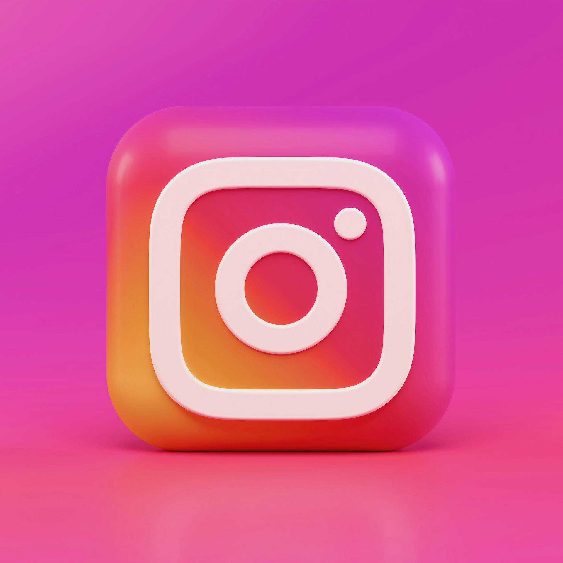 Brightly colored instagram symbol on pink and purple background