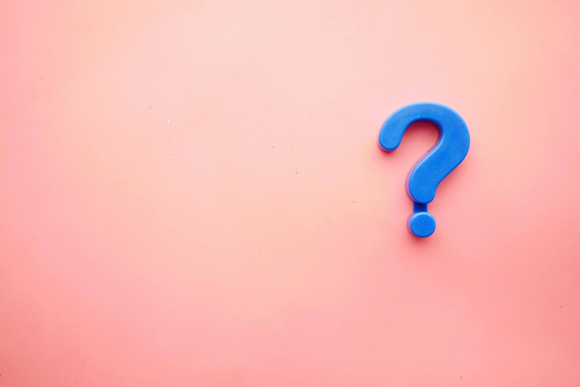 What to ask yourself when looking into media intelligence software solutions. Image showing blue question mark on bright pink backgound