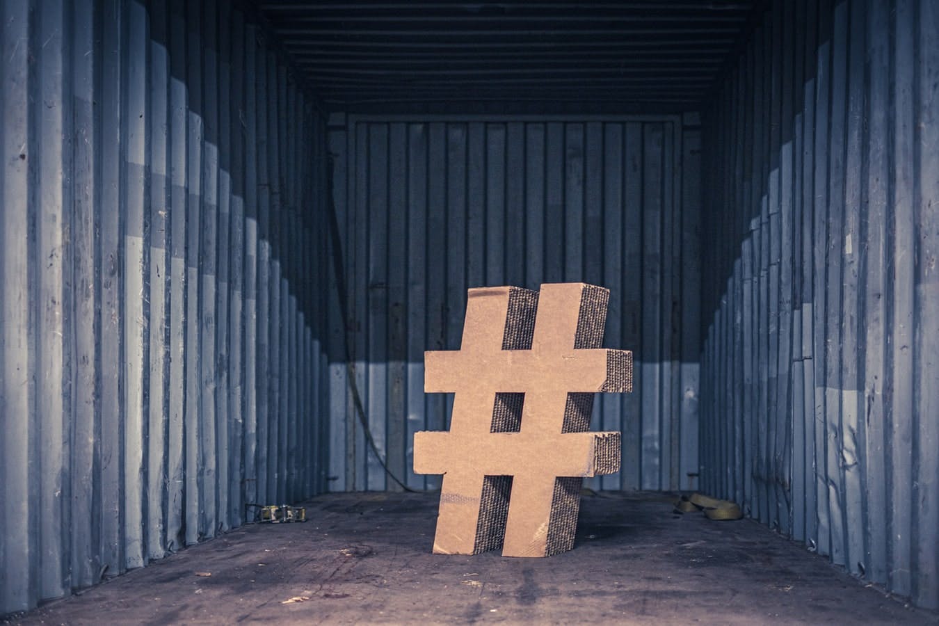 large hashtag sign in a corrugated iron room 
