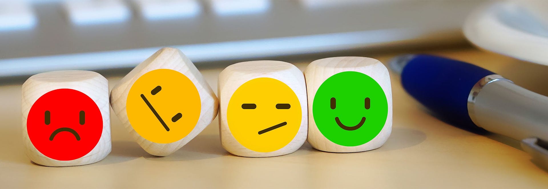 Dice with happy and sad faces on