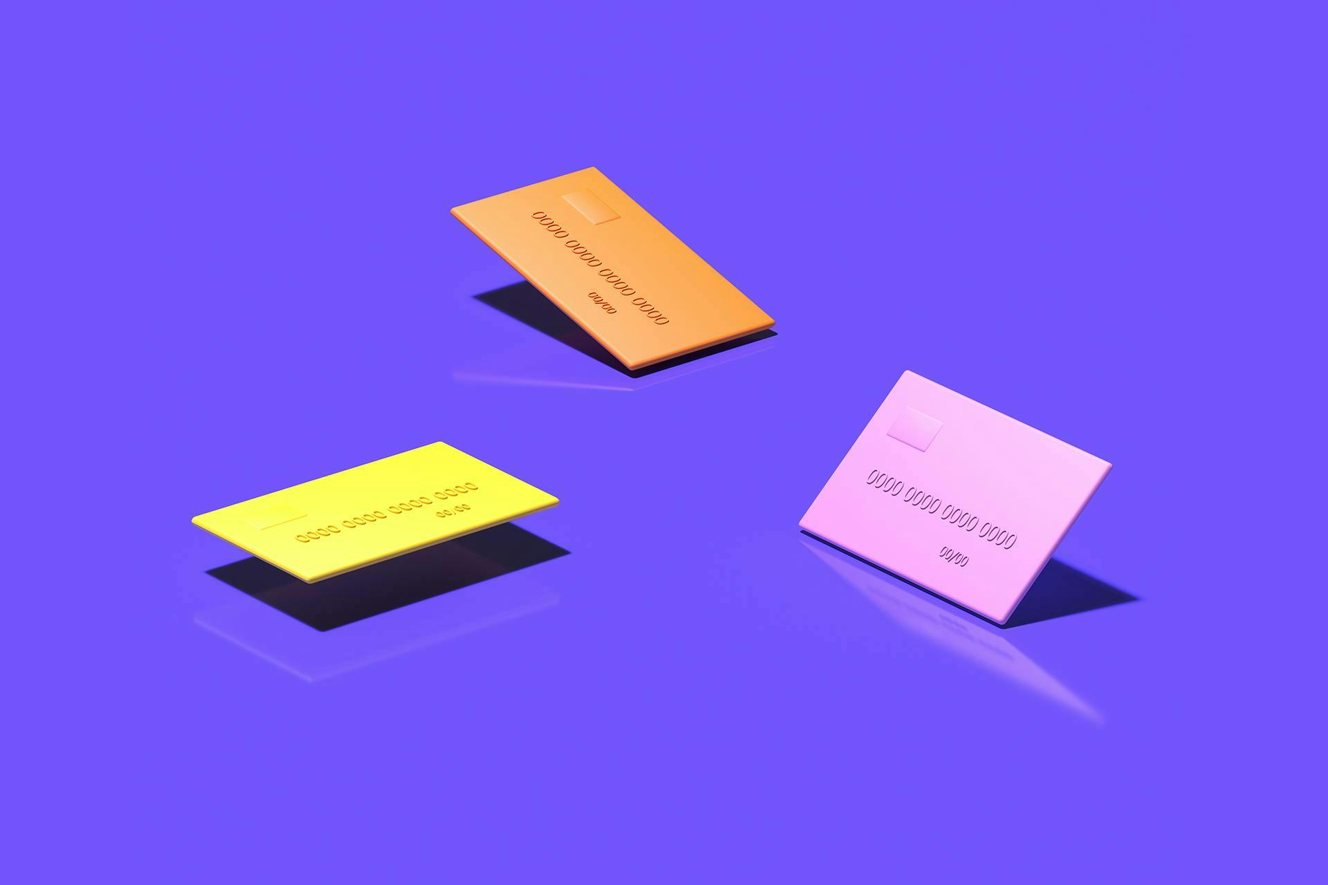 Three cartoon renderings of credit cards in pink, orange and yellow on a solid purple background. If your influencer marketing campaign is successful, then your customers are likely to pull out their credit cards for real. 