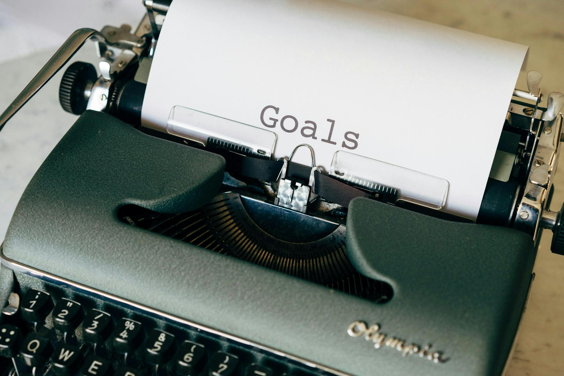 Typewriter with paper listing Goals. Knowing your goals and KPIs are crucial for an influencer strategy