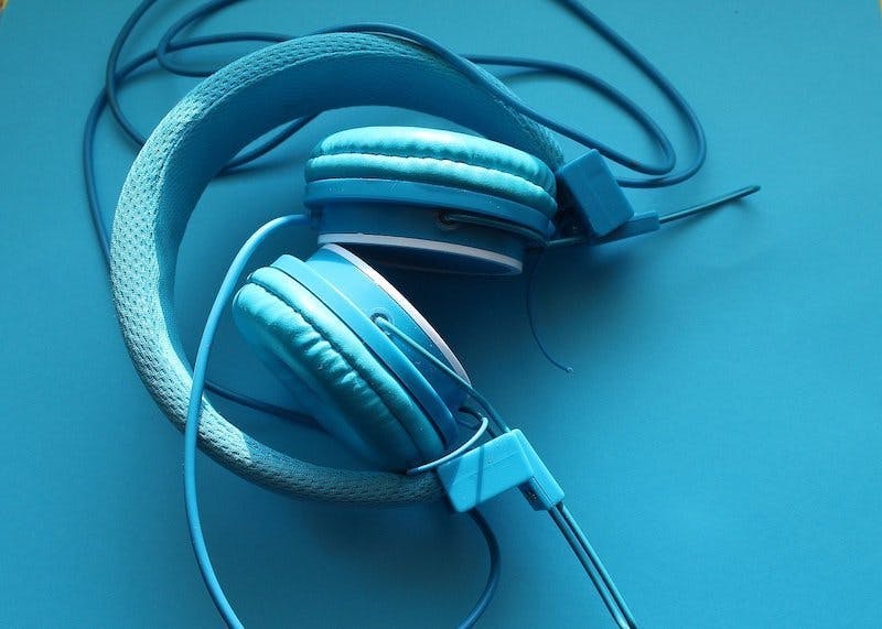 Blue headphones on a blue background