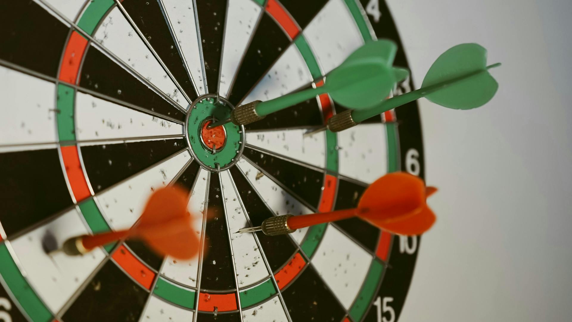 Dart board with several darts, one in the bullseye. An influencer marketing strategy is essential for the success of your influencer program