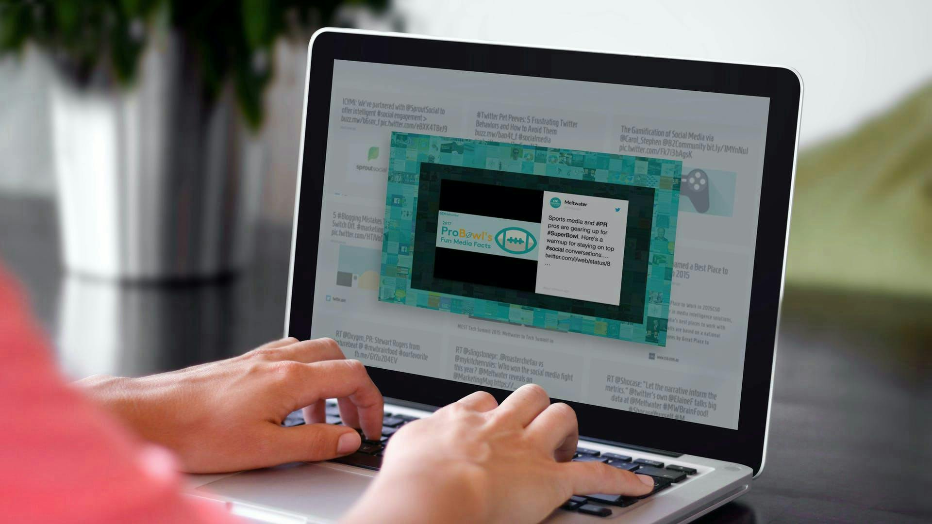 Photo of a woman working in the Meltwater Media Intelligence Platform using the internal newsletter functionality