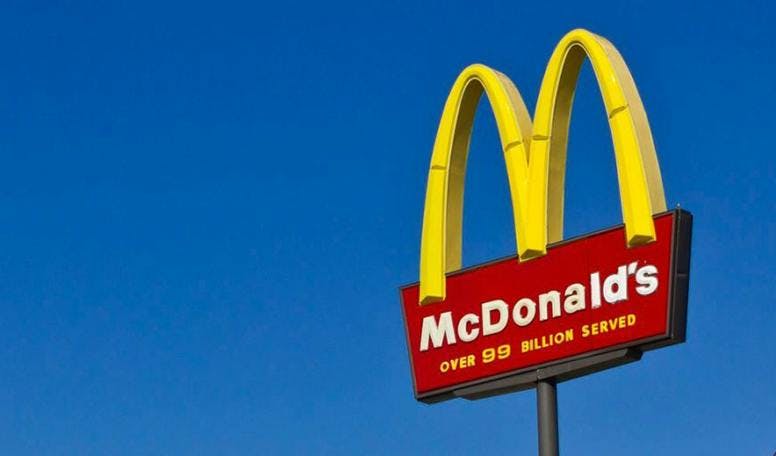 McDonald's logo afgezet tegen een heldere blauwe achtergrond