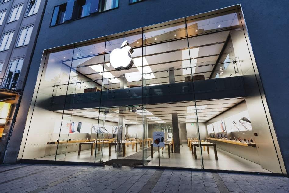 An image of an Apple store with the iconic logo featured on the front