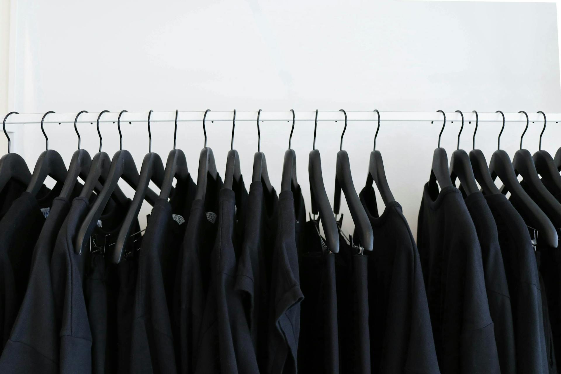 Row of identical black coats on hangers in a closet. Not all social media sites are the same.