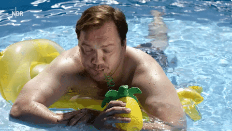 GIF of man in a blue pool on a yellow floating device