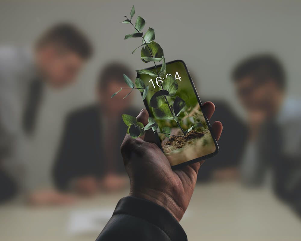 Image of a smartphone in someone's hand where a real plant is growing out of it into the real world. This image displays how growth hacking took over the world.