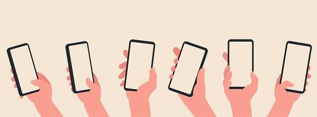 Hands holding mobile phones on orange background