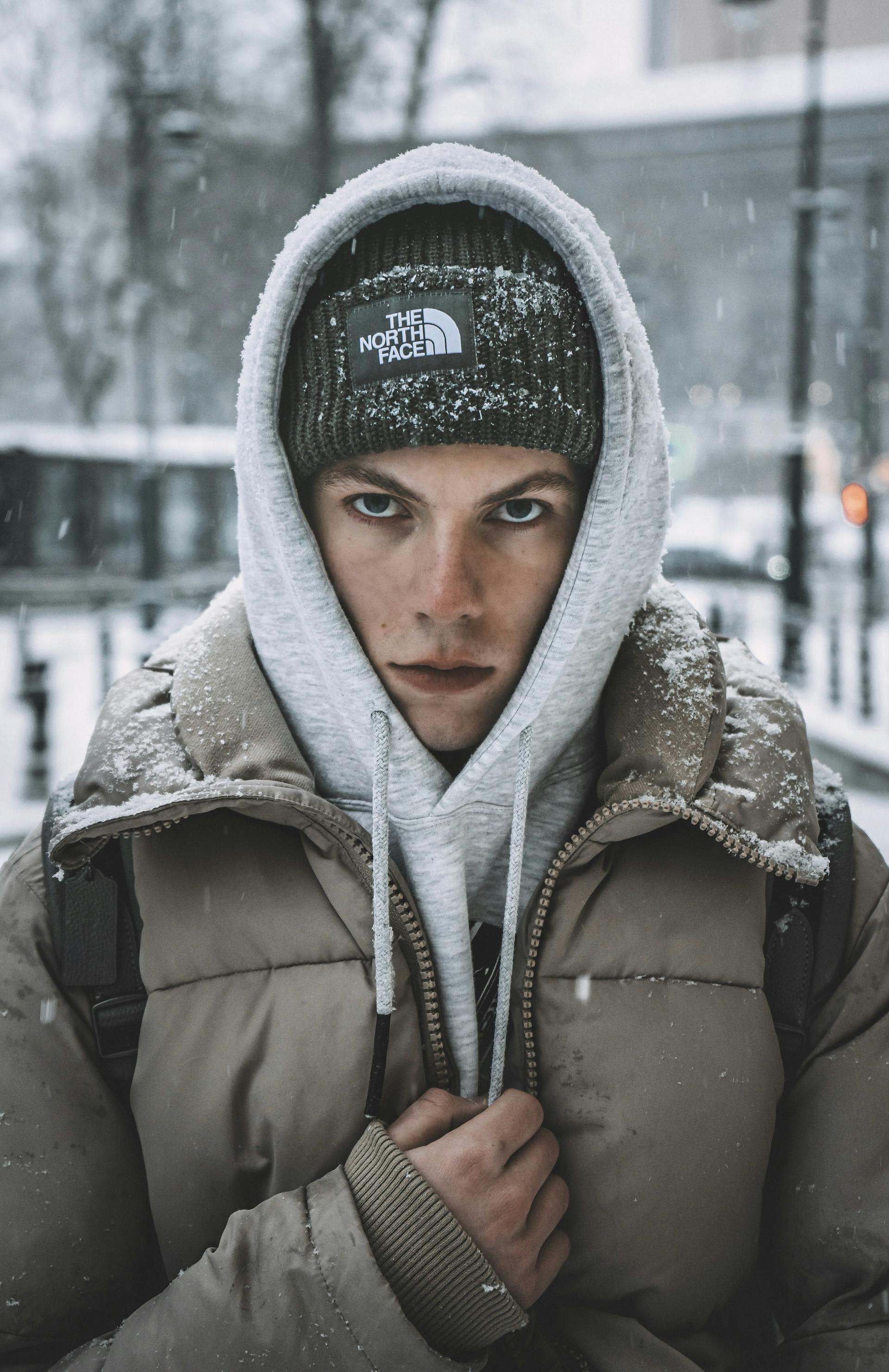 Man wearing North Face branded clothing in the snow being a brand ambassador