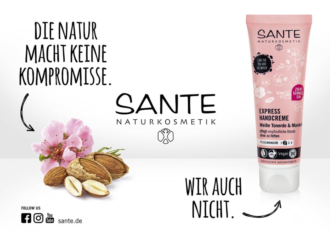Handcreme von Sante Naturkosmetik mit den Texten: "Die Natur mach keine Kompromisse." und "Wir auch nicht.", Mandeln und eine rosa Blüte