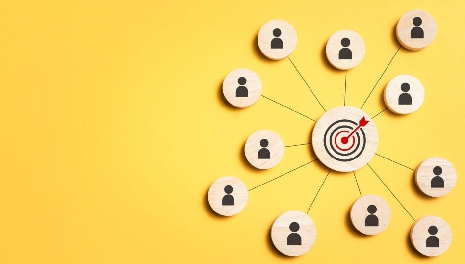 Image of a target with customer icons connected to it to symbolize using customer segmentation tools