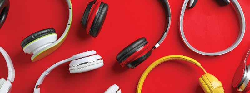 multiple headphones on a red background