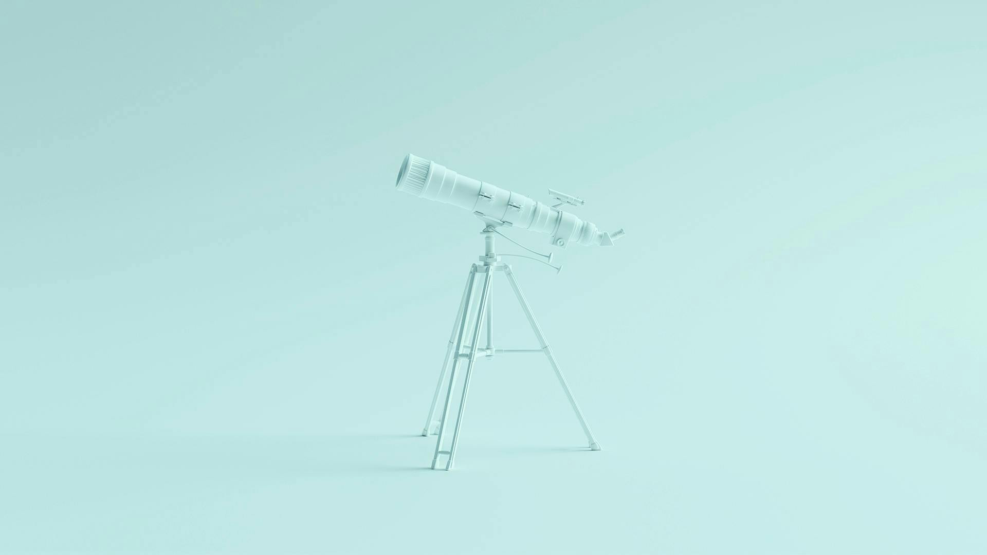 Un téléscope bleu pointant vers la gauche sur un fond bleu clair