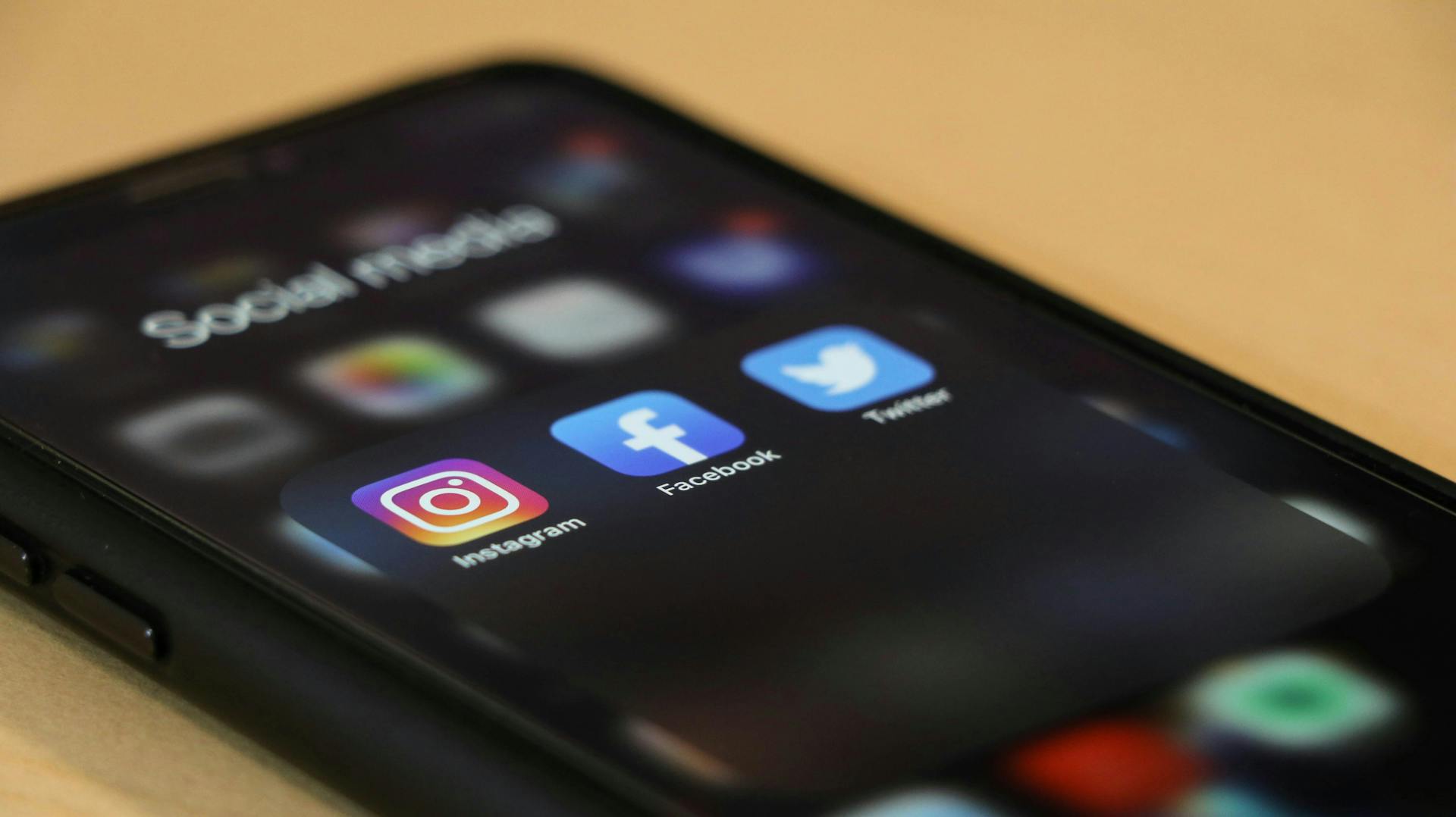 Smart phone showing top social media channel icons lit up: Instagram, Facebook, Twitter
