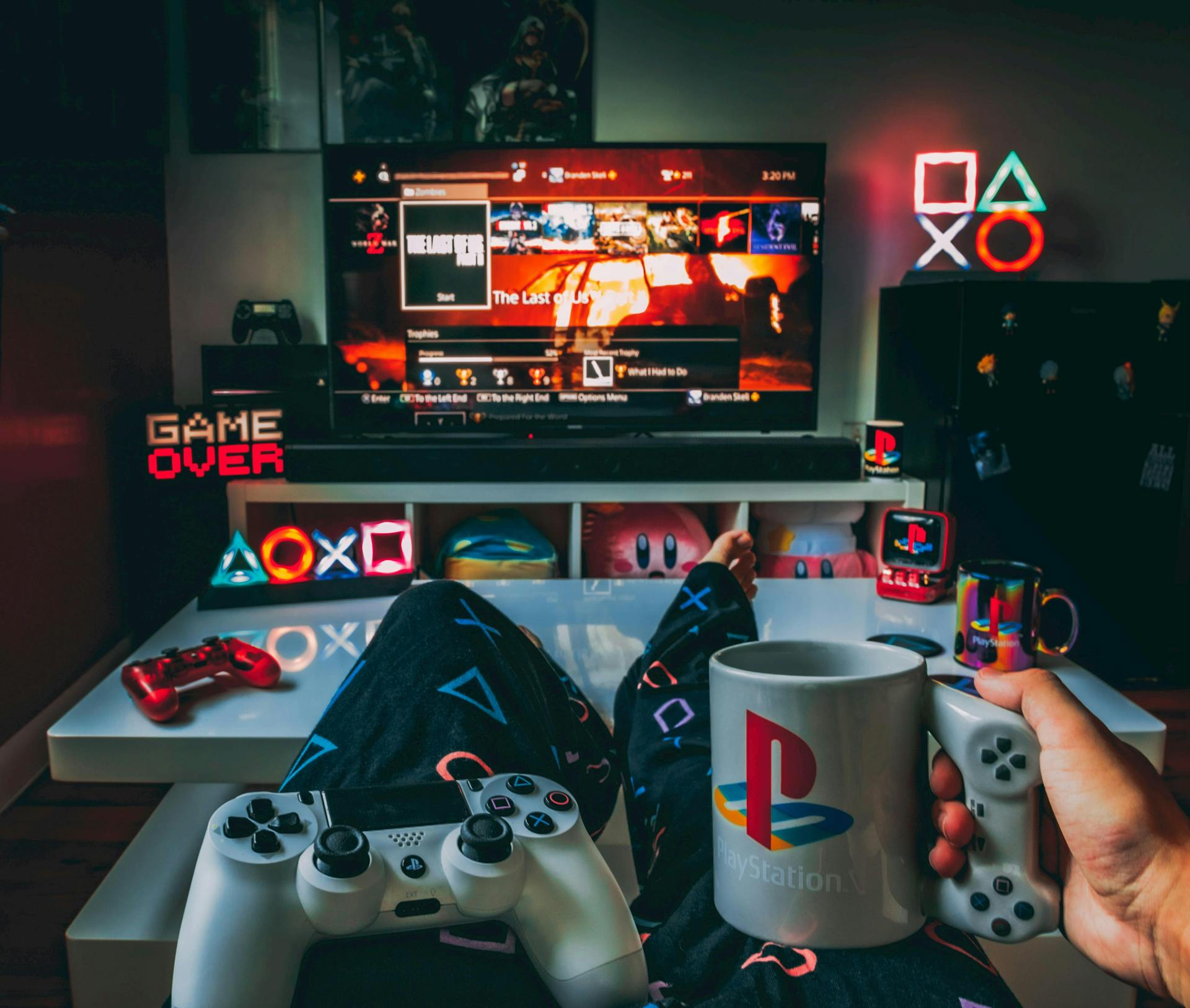Brand ambassador playing playstation surrounded by playstation merchandise