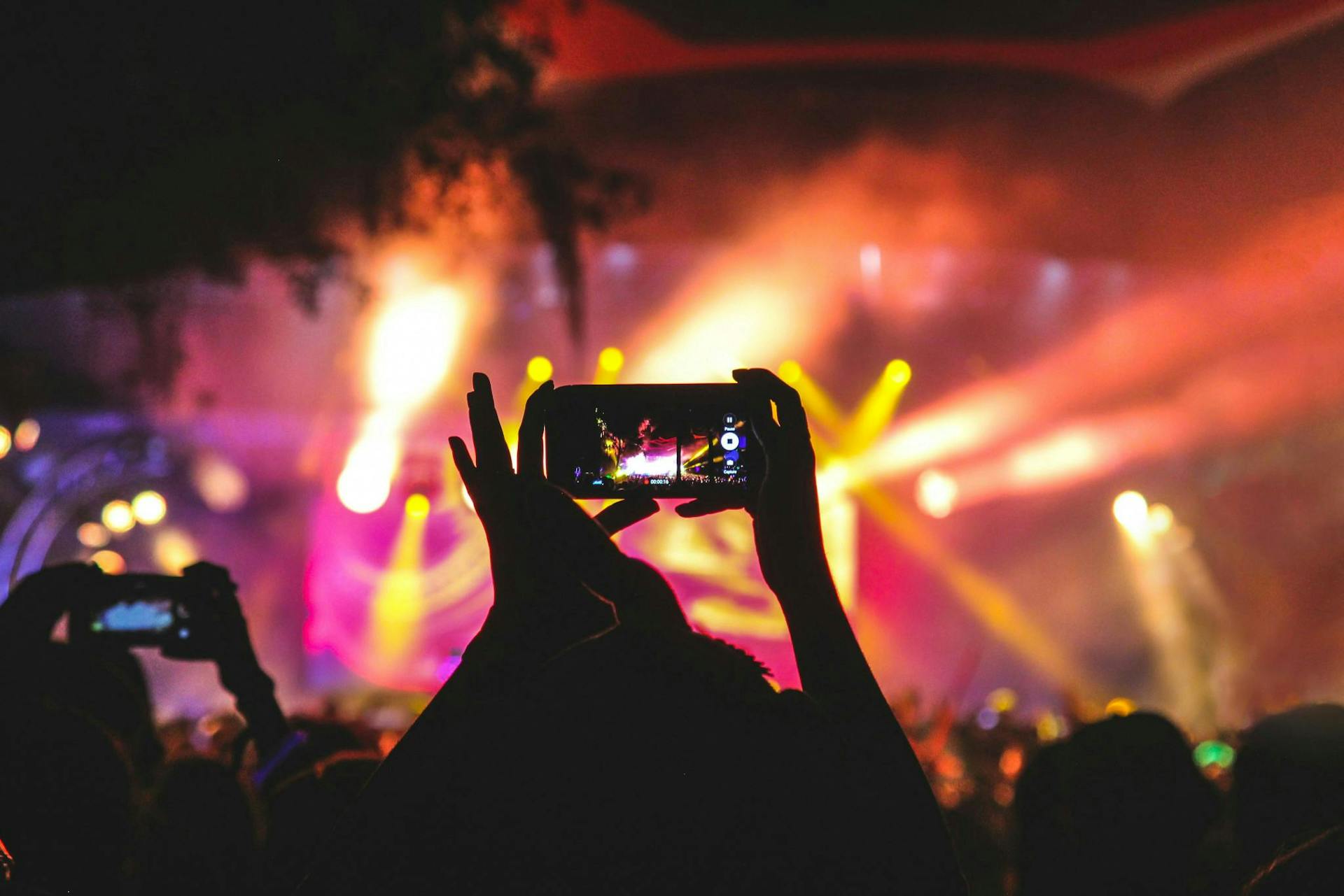 Photo of someone filming a concert